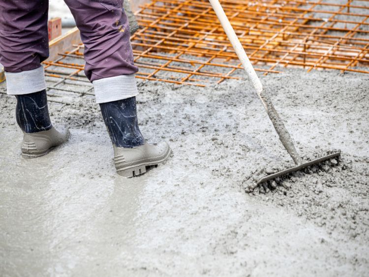 Worker Is Spreading Concrete Using Concrete Tool 1