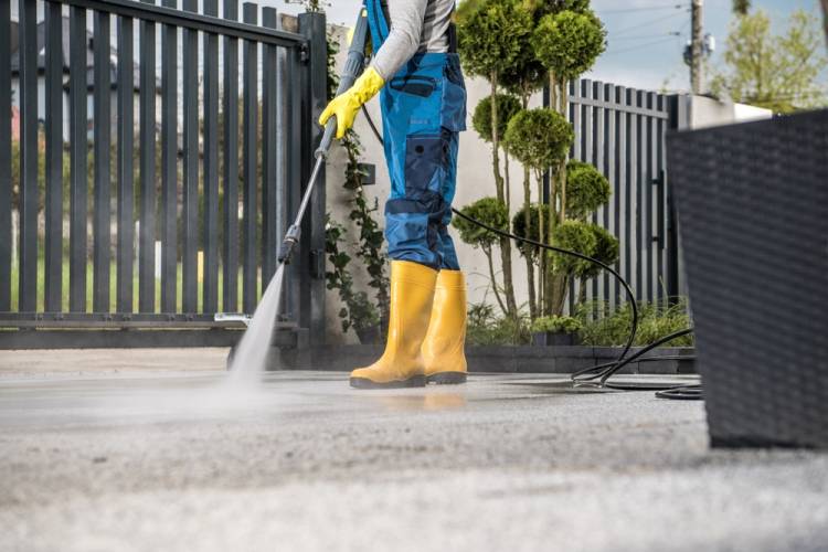 Worker Cleaning Exposed Aggregate Retarder driveway