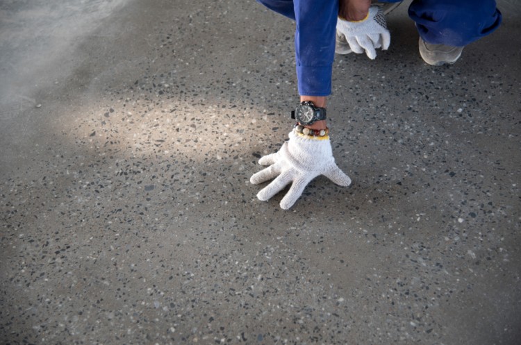 Construction Worker Check Quality Of Concrete Hardner Floor